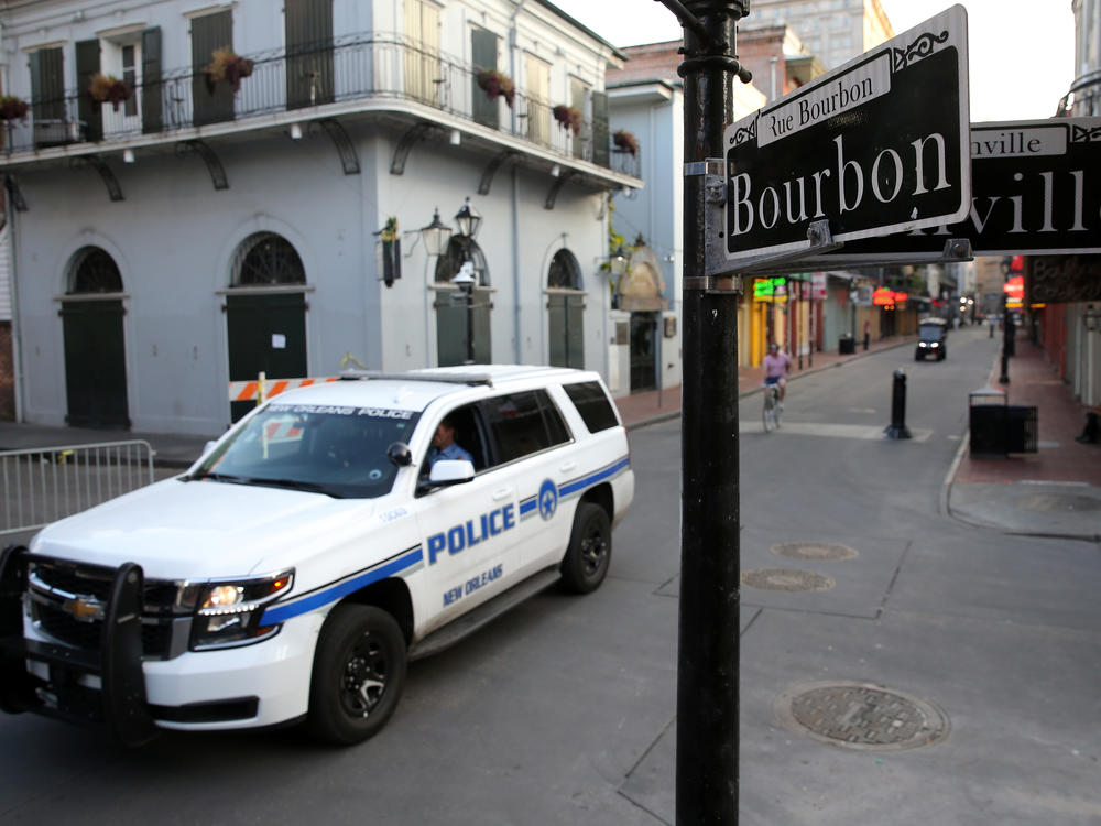 A New Orleans police vehicle patrols Bourbon Street.