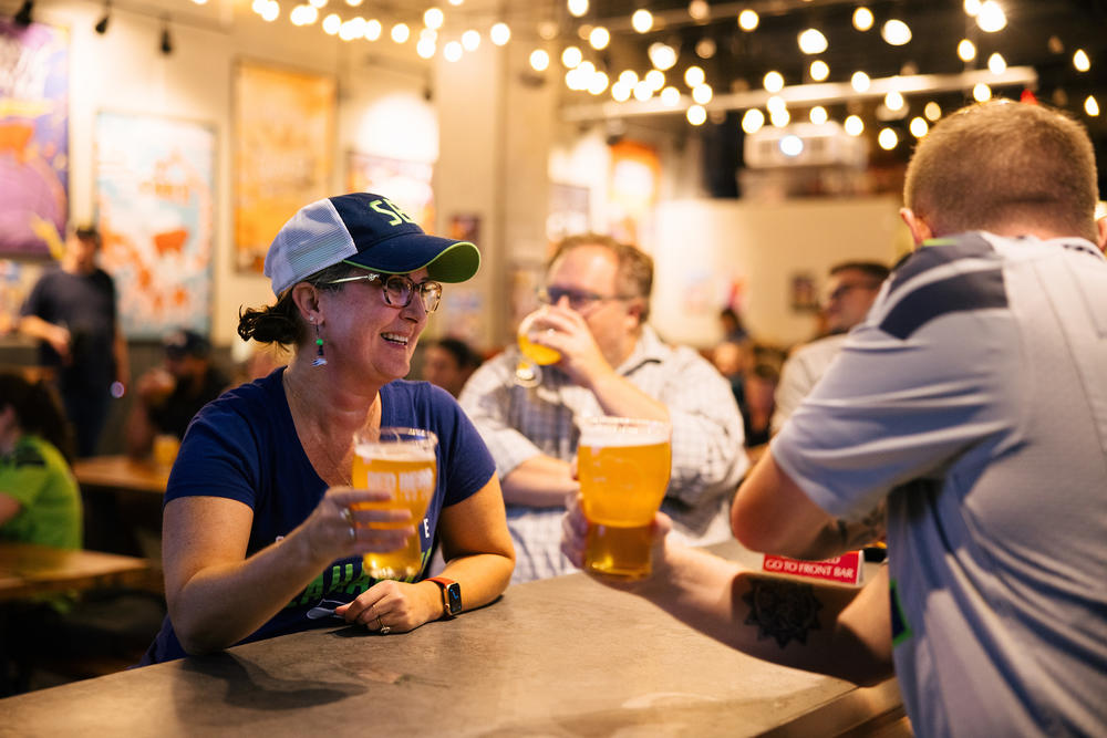 Michelle Webster (left), who grew up in Washington State, watches the Seattle Seahawks game against the Denver Broncos at Red Bear Brewing in Washington, D.C. on Sept. 12.