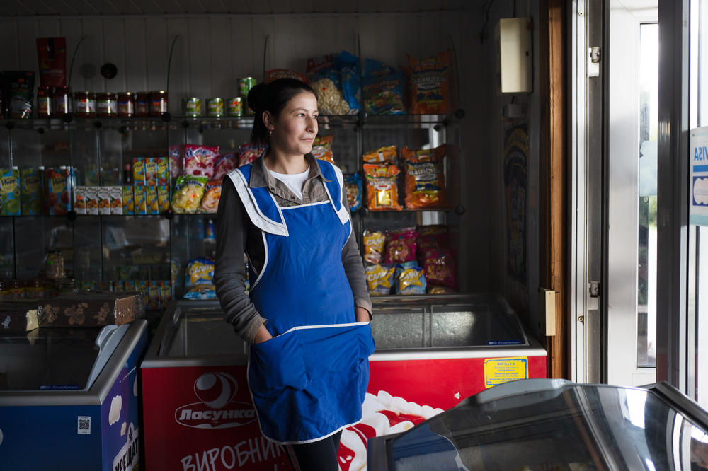 Oksana Zelenyuk works in the local mini-mart in Maksymivka, a village just across the Dnipro River from Russian-controlled areas. The villagers there are now separated from friends and family and have been unable to see them for months.