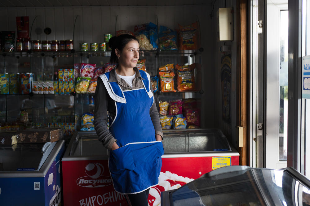 Oksana Zelenyuk works in the local mini-mart in Maksymivka, a village just across the Dnipro River from Russian-controlled areas. The villagers there are now separated from friends and family and have been unable to see them for months.
