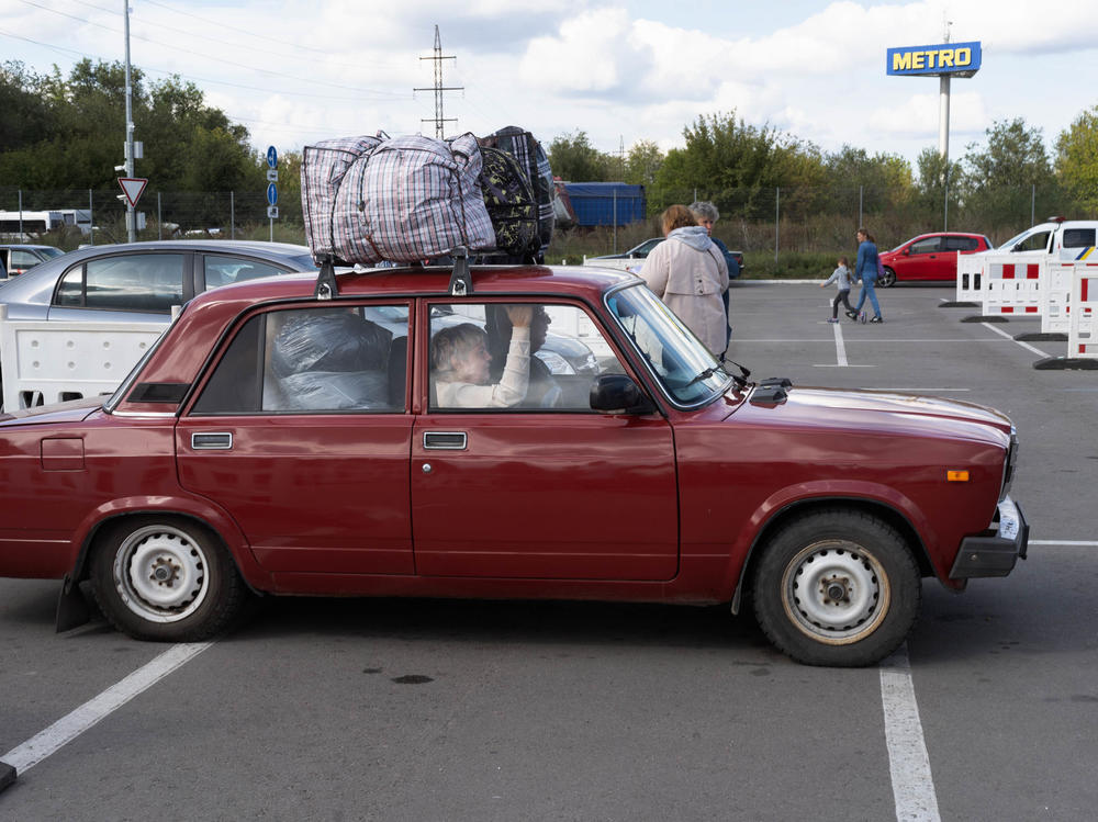 People arrive at a parking lot in Zaporizhzhia from places like Melitopol and Kherson, areas that have been occupied by Russia for months now.