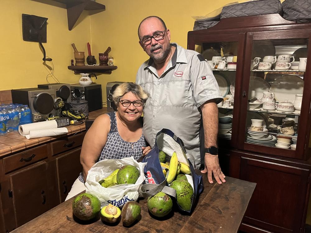 Magaly Vázquez and Pedro Lugo, with the avocados and bananas that friends have given them after Hurricane Fiona knocked much of the island's fruit off trees.