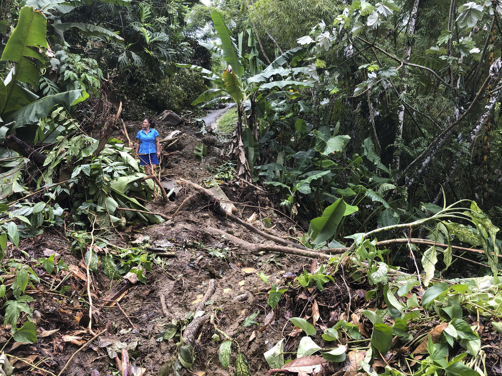 Nancy Galarza looks Thursday at the damage that Hurricane Fiona inflicted on her community, which remained cut off days after the storm slammed the rural community of San Salvador in the town of Caguas, Puerto Rico.