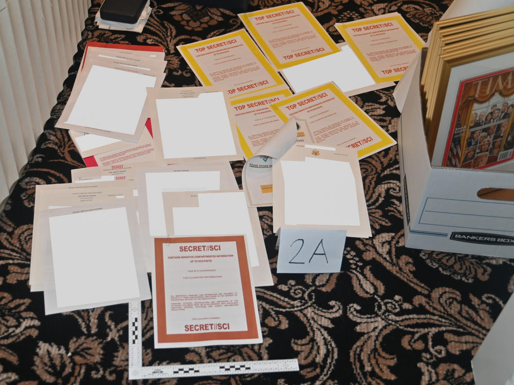 This image contained in a court filing by the Department of Justice, and partially redacted by the source, shows documents seized during the Aug. 8 FBI search of former President Donald Trump's Mar-a-Lago estate.