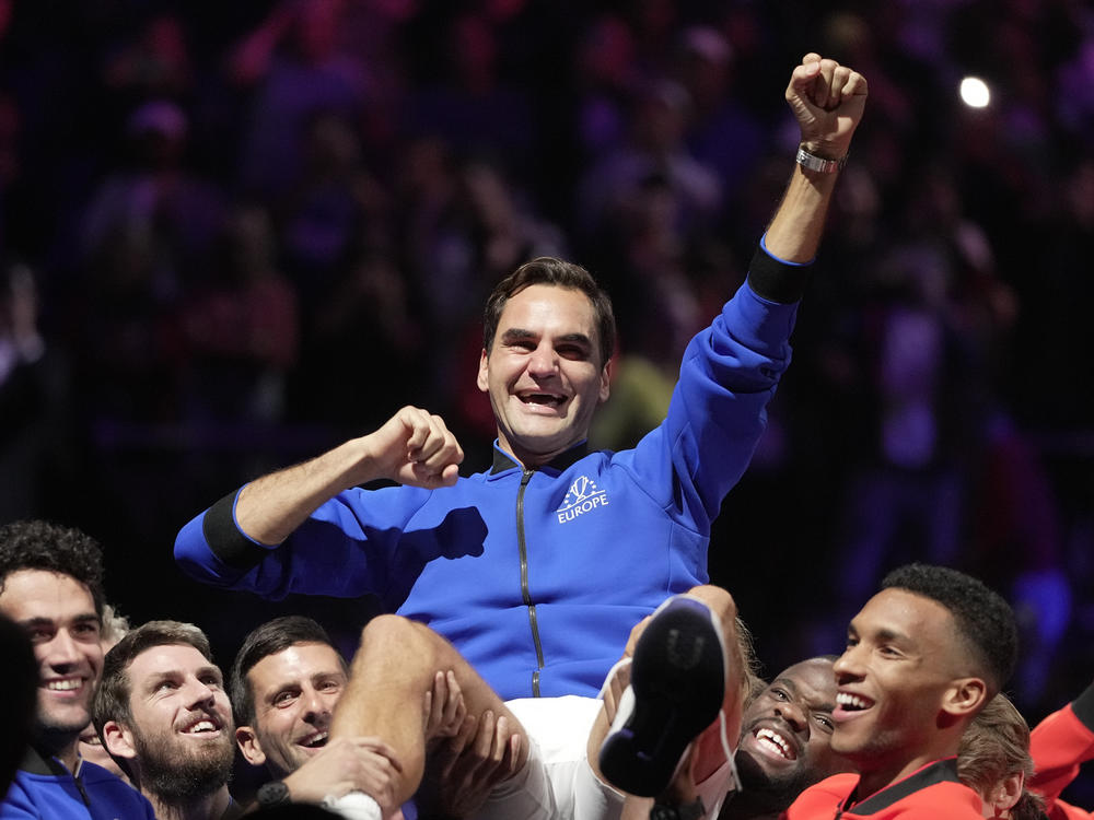 Team Europe's Roger Federer is lifted by fellow players after playing with Rafael Nadal in a Laver Cup doubles match against Team World's Jack Sock and Frances Tiafoe at the O2 arena in London, Friday, Sept. 23.