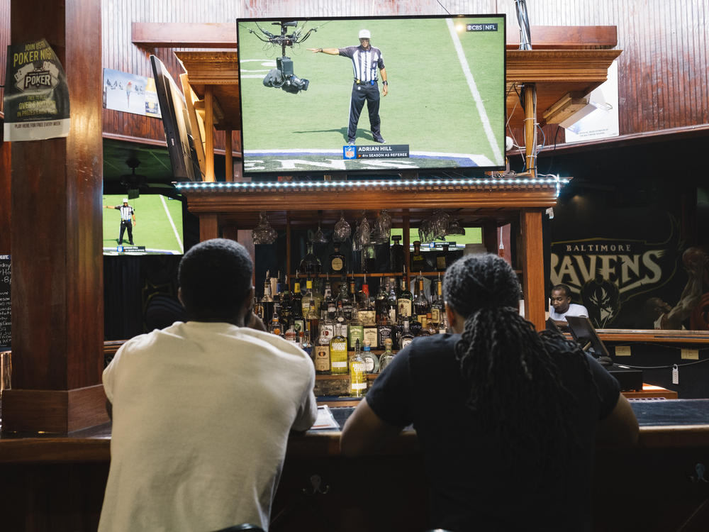Football fans watch the Baltimore Ravens vs. Miami Dolphins at the Hamilton Sports Bar and Grill in Baltimore on Sept. 18.