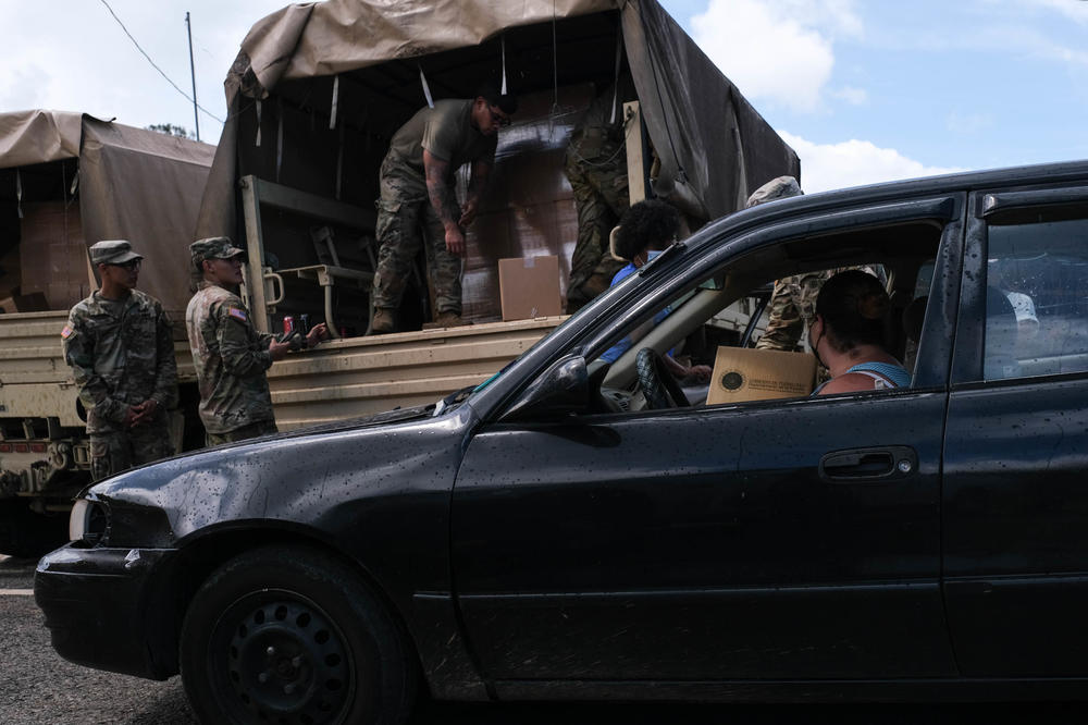 The Department of Family of Puerto Rico and the National Gaurd distribute food at an intersection of the communities of Orocovis, Puerto Rico on Sept. 22, 2022.