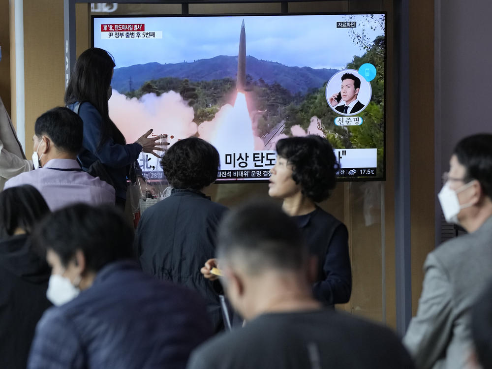 People watch a news program showing a file image of a missile launch by North Korea at the Seoul Railway Station on Sunday. South Korea has accused its neighbor of raising tensions in the region after firing a ballistic missile toward the sea.
