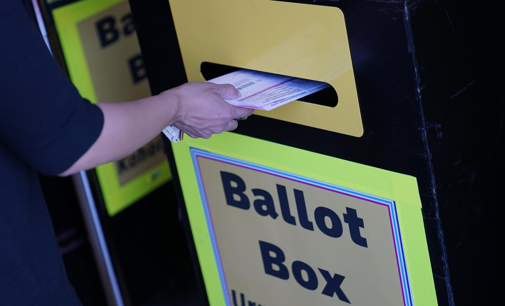 In this 2020 file photo, a person places a mail-in ballot in a drop box at the Clark County Election Department in Las Vegas.