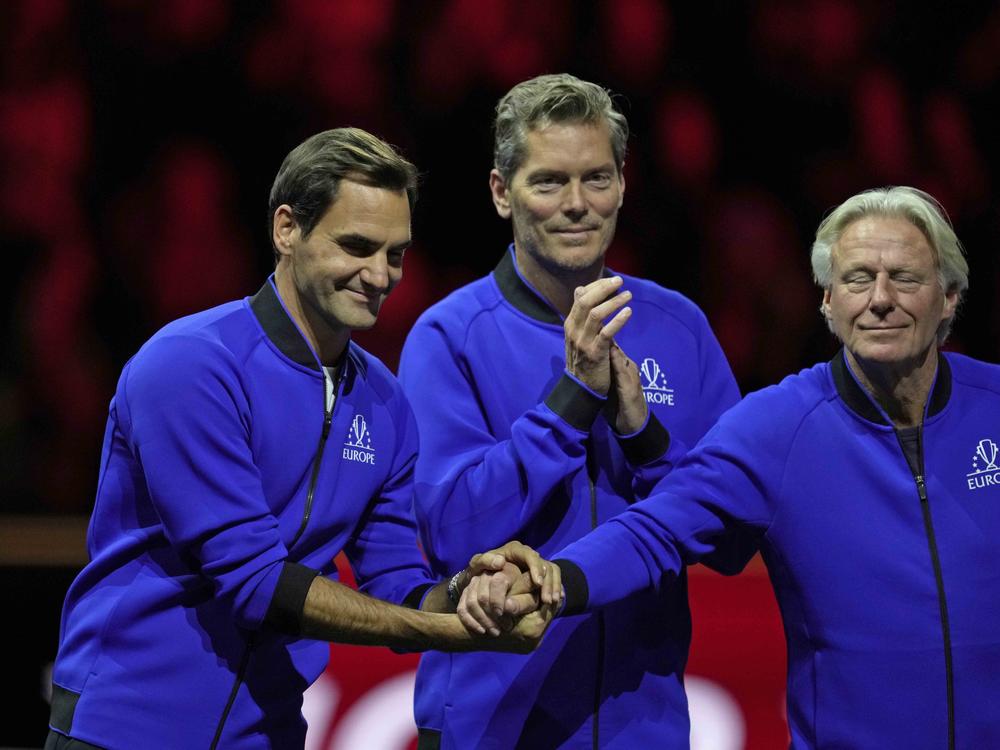 Team Europe's captain Bjorn Borg, right, holds the hands of his player Roger Federer at the end of the Laver Cup tennis tournament at the O2 arena in London on Sunday.