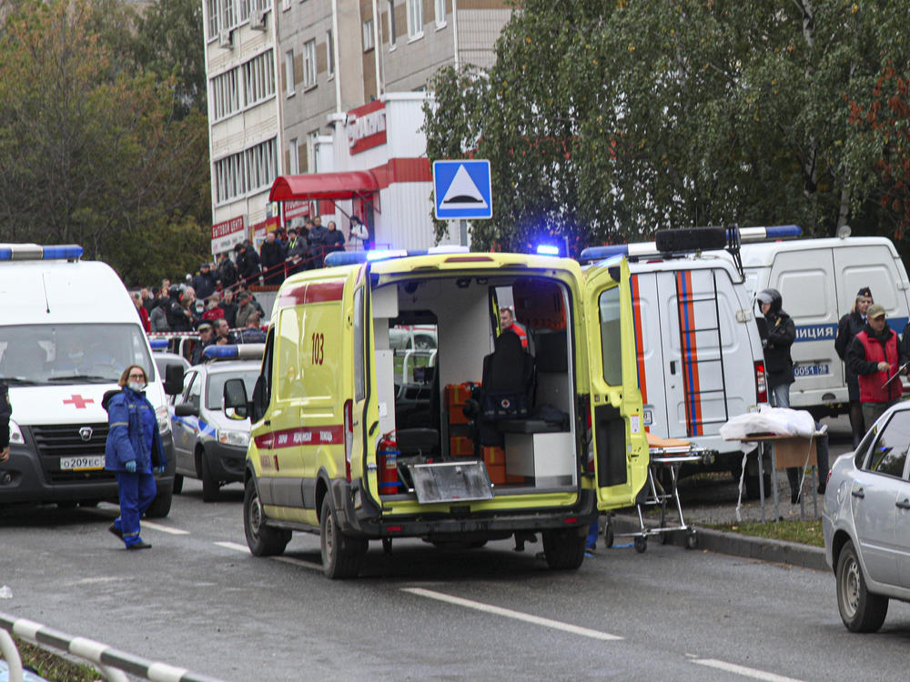 Police and paramedics work at the scene of a shooting at school No. 88 in Izhevsk, Russia, Monday, Sept. 26, 2022. A gunman on Monday morning killed 13 people and wounded 21 others in a school in central Russia, authorities said.
