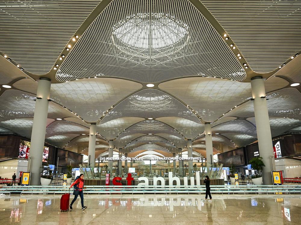 Passengers walk in the new hall of Istanbul Airport on the first day after moving from Ataturk International airport on April 6, 2019, in Istanbul. Many Russian men (not pictured) have been buying up tickets for Turkey since their government issued a draft to fight in Ukraine.