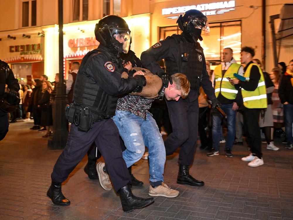 Police officers detain a man in Moscow on Wednesday, following calls to protest against mobilization announced by President Vladimir Putin.