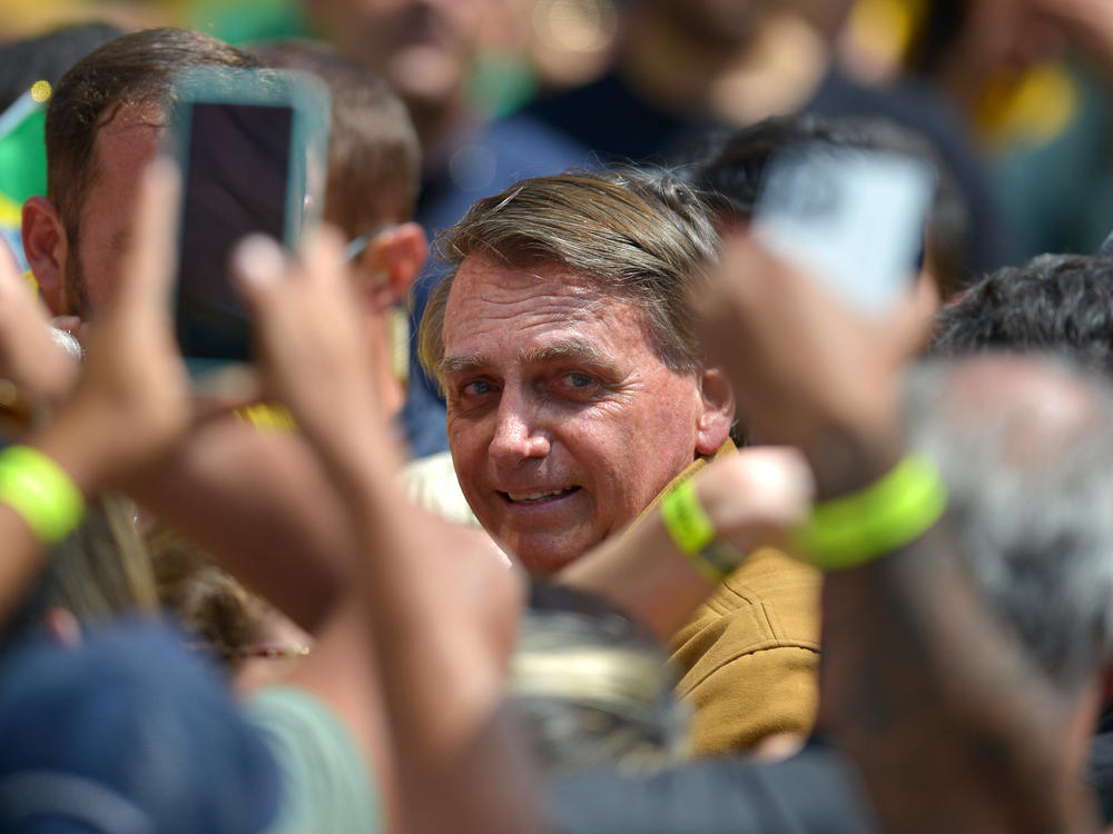 Brazil's President Jair Bolsonaro greets supporters during a reelection campaign rally. Ahead of the first round of voting on Oct. 2, Bolsonaro has baselessly claimed that voting machines will be rigged against him, an echo of former U.S. President Donald Trump's false claims about the 2020 election.