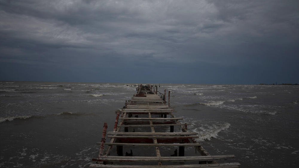Waves kick up under a dark sky Monday along the shore of Batabano, Cuba. Hurricane Ian was growing stronger as it approached the western tip of Cuba.