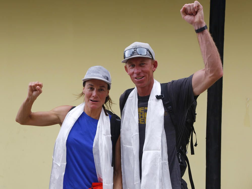Hilaree Nelson of Telluride, Colorado, left and James Morrison of Tahoe, California, raise their fists as the pair arrived in Kathmandu, Nepal, in 2018. Rescuers in a helicopter were searching on the world's eighth-highest mountain Tuesday for Nelson, the famed U.S. ski mountaineer, a day after her trip organizer said she fell off the mountain near the peak.