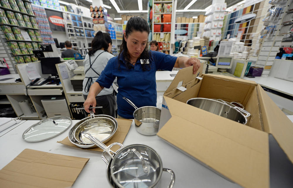 A store manager packs cookware at Bed Bath & Beyond in Los Angeles in April 2013.