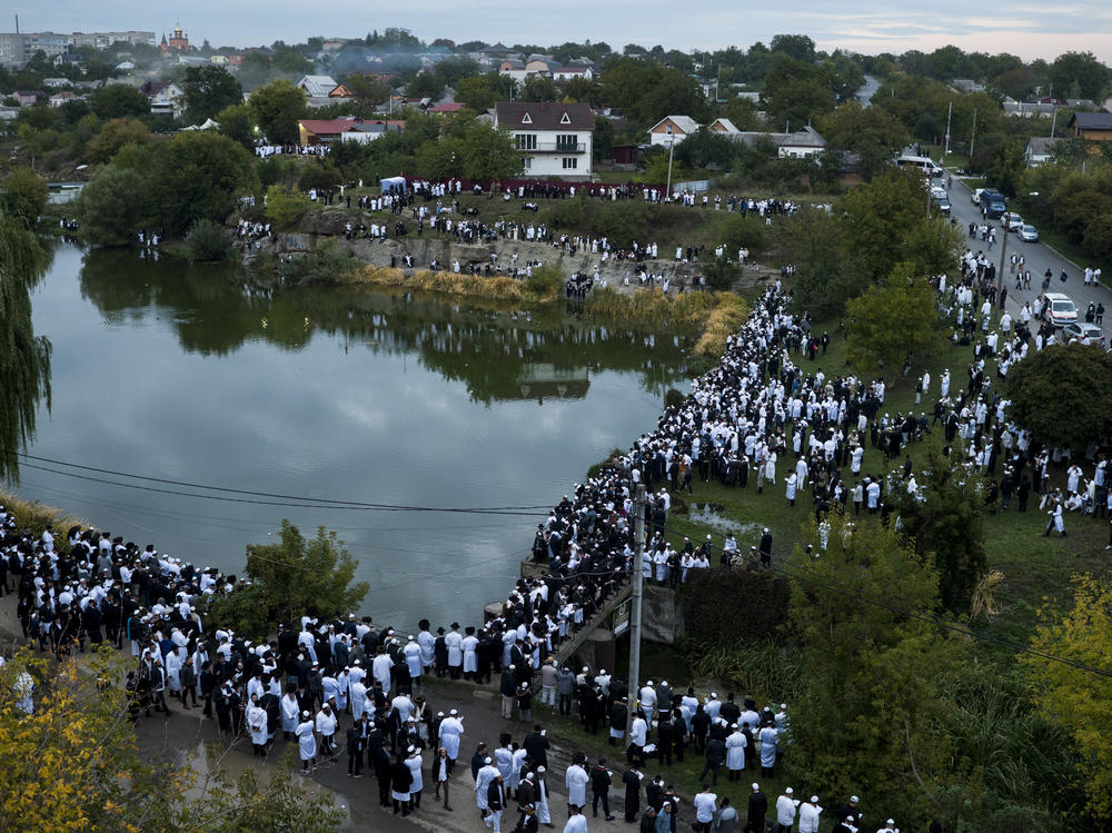 Jewish pilgrims gather at a lake to perform Tashlikh, an atonement ritual that involves symbolically casting one's sins into a body of water, during the Rosh Hashanah pilgrimage to Rabbi Nachman's tomb in Uman, Ukraine on Monday. Despite Russia's invasion of Ukraine, a reported 23,000 adherents made the trip, which was complicated by the grounding of civilian aviation throughout Ukraine.