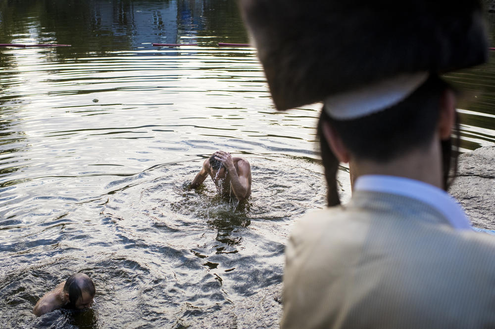 Hasidic pilgrims ritually bathe in a lake during the annual Rosh Hashanah pilgrimage to Rabbi Nachman's tomb.