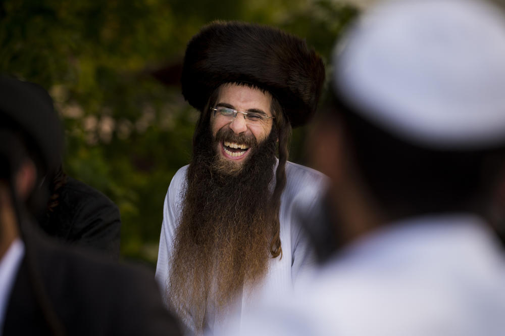 A man laughs while singing and dancing during the annual pilgrimage to Rabbi Nachman's tomb in Uman.