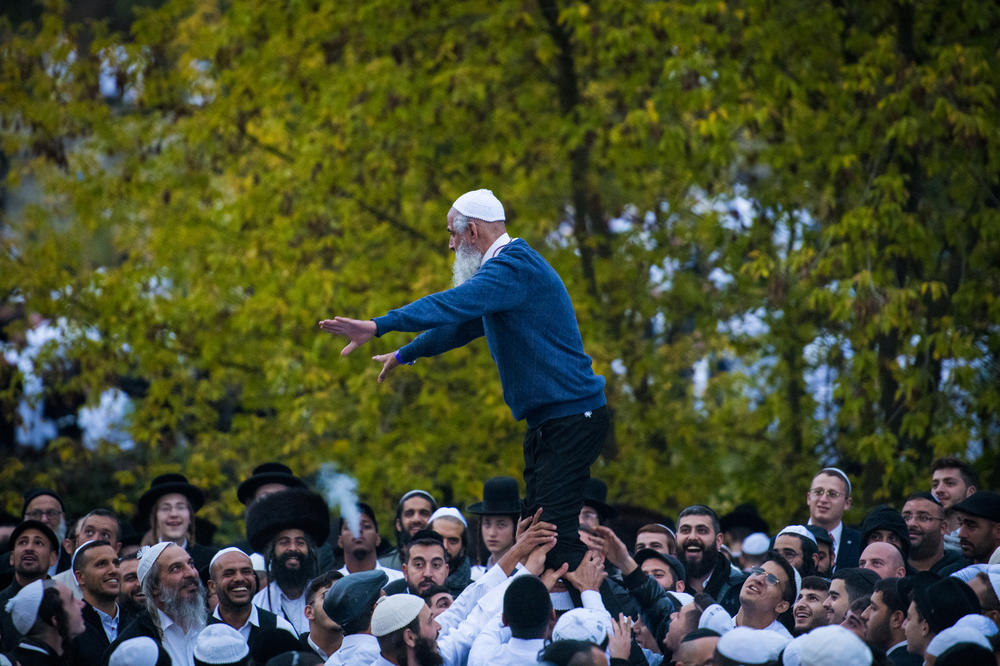A man leads the crowd in chants and songs during the annual Rosh Hashanah pilgrimage.