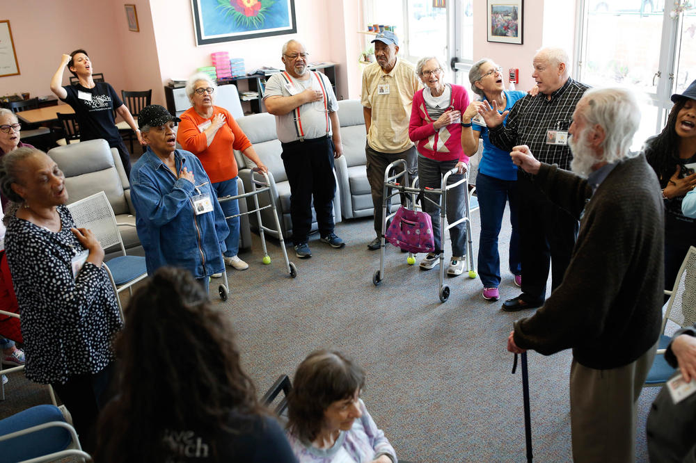 Clients at the Florence Gray Soltys Adult Day Health Program in Hillsborough, N.C. sing the national anthem along with dementia expert Teepa Snow in spring of this year. Singing can help relieve dementia symptoms and maintain brain function, and can help individuals communicate when they no longer have words.
