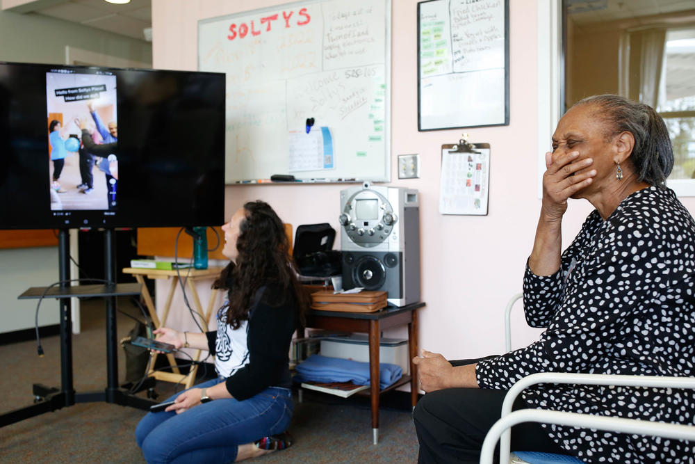 Ann Betts (right) reacts to a TikTok video that Amanda Bulgarelli (left) plays for her.