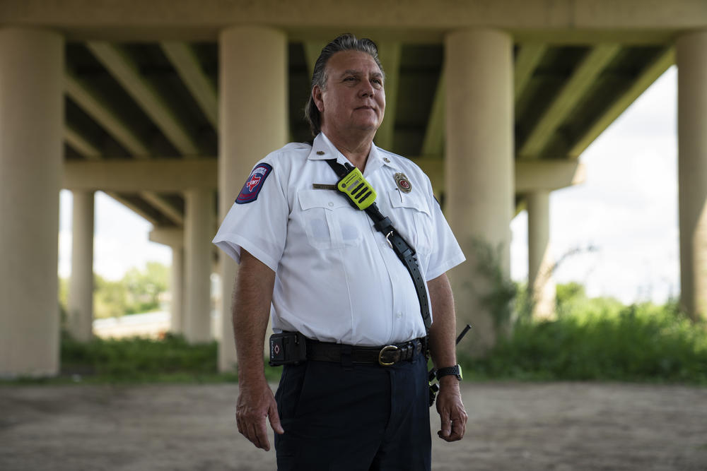 Manuel Mello, the chief of the Eagle Pass Fire Department, under an international bridge in Eagle Pass, Texas.