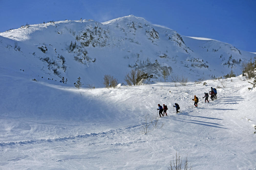 Tourists ski near the Chornohora mountain range, part of the Carpathian Mountains, in western Ukraine on Feb. 21, 2021, one year before the Russian invasion.