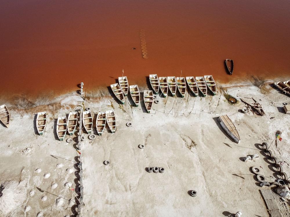 This areal view shows rows of boats used for harvesting salt in Lake Retba in Senegal in 2021.