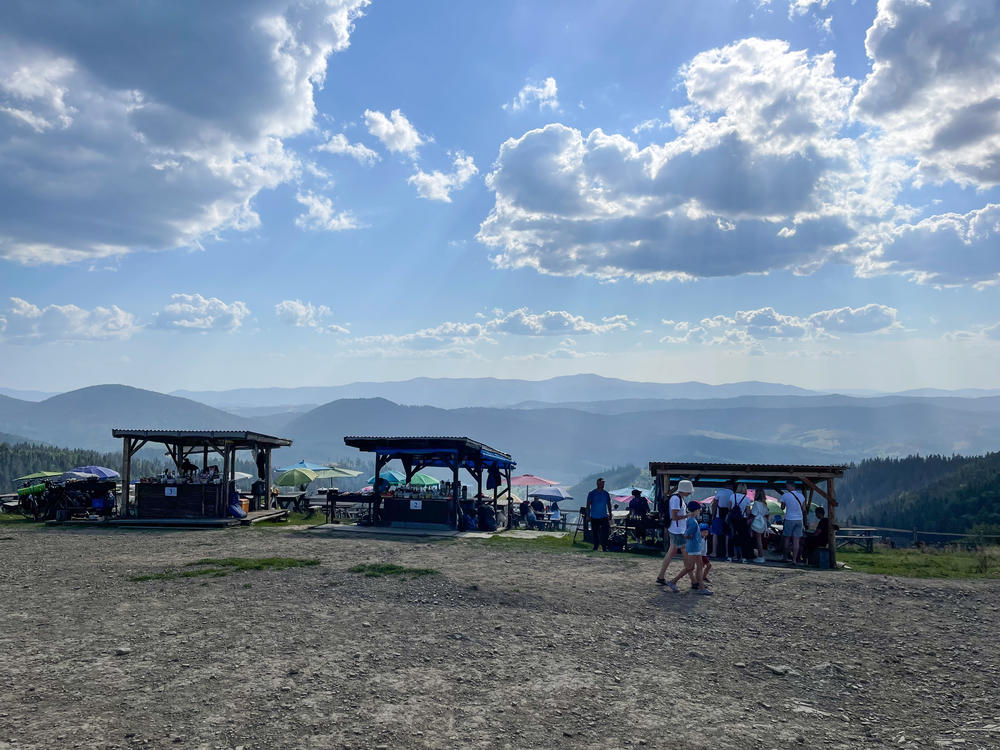 Vendors sell food, beverages and souvenirs at a lookout spot in Slavske, Ukraine, in August. The week of Ukrainian Independence Day, the tourist town saw a small spike in visitors, but overall tourism this summer was down significantly across the Carpathian Mountains because of the war.