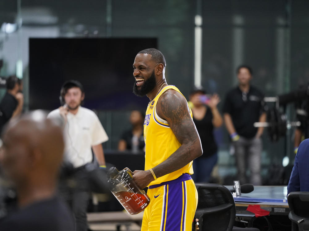 Los Angeles Lakers' LeBron James shares a laugh with staff members during the NBA basketball team's Media Day Monday, Sept. 26, 2022, in El Segundo, Calif.