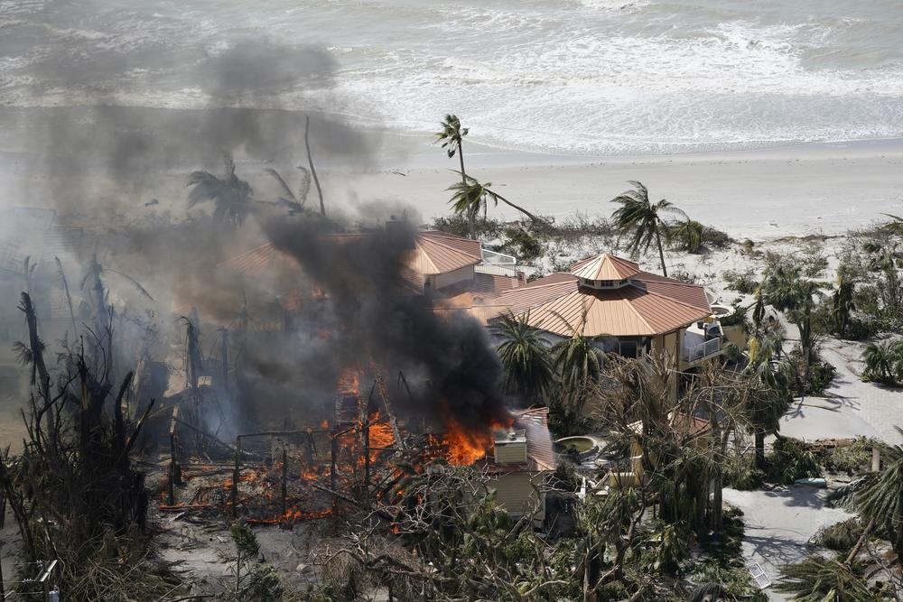 A home burns on Sanibel Island in the wake of Hurricane Ian, Thursday, Sept. 29, 2022, in Fla.