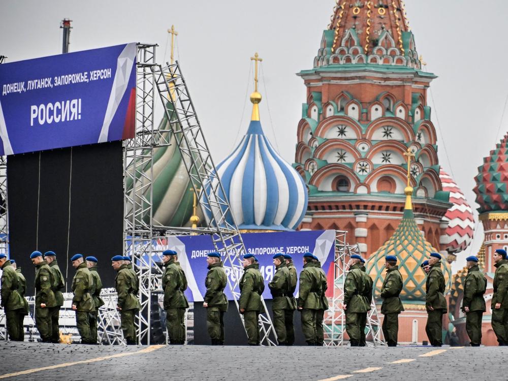 Russian soldiers stand on Red Square in central Moscow on Thursday as the square is sealed off prior to a ceremony for the alleged incorporation of new territories into Russia. Banners on the stage read: 
