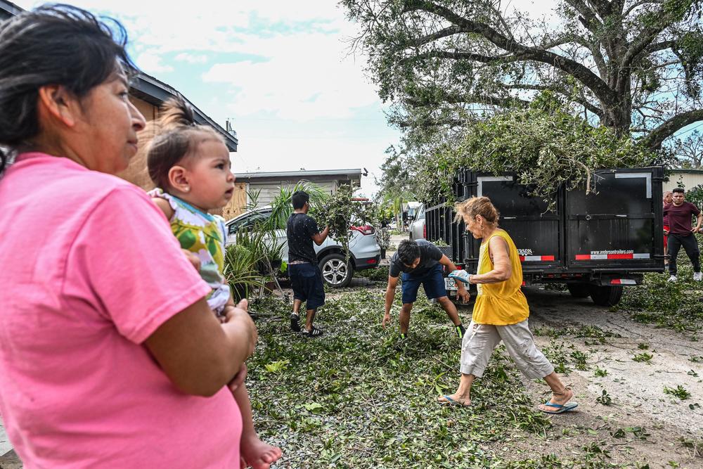 Residents of mobile homes clean up debris in the aftermath of Hurricane Ian, in Fort Myers, Florida, on September 29, 2022.