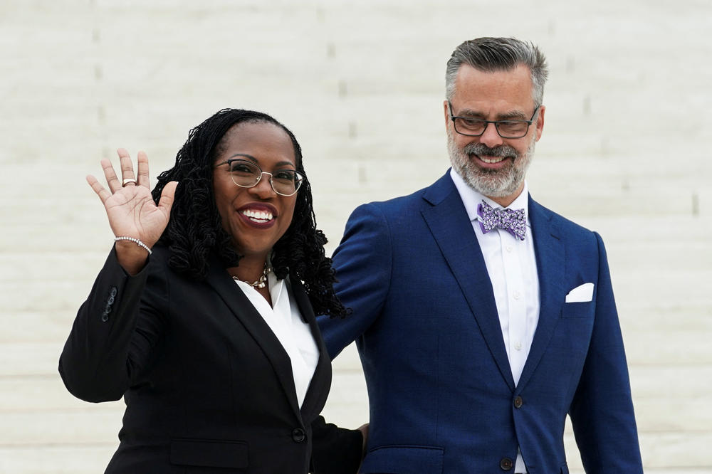 U.S. Supreme Associate Justice Ketanji Brown Jackson waves with her husband, Dr. Patrick Jackson, outside the Supreme Court following her investiture ceremony at the court on Sept. 30, 2022.