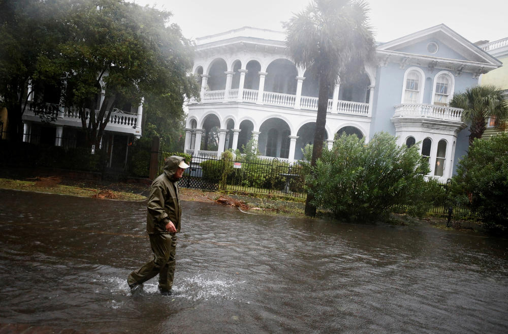 A local resident walks in a flooded street as Hurricane Ian bears down on Charleston, S.C., on Sept. 30. Ian hit southwest Florida as a Category 4 storm before crossing over into the Atlantic and is now hitting South Carolina as a Category 1 storm near Charleston.