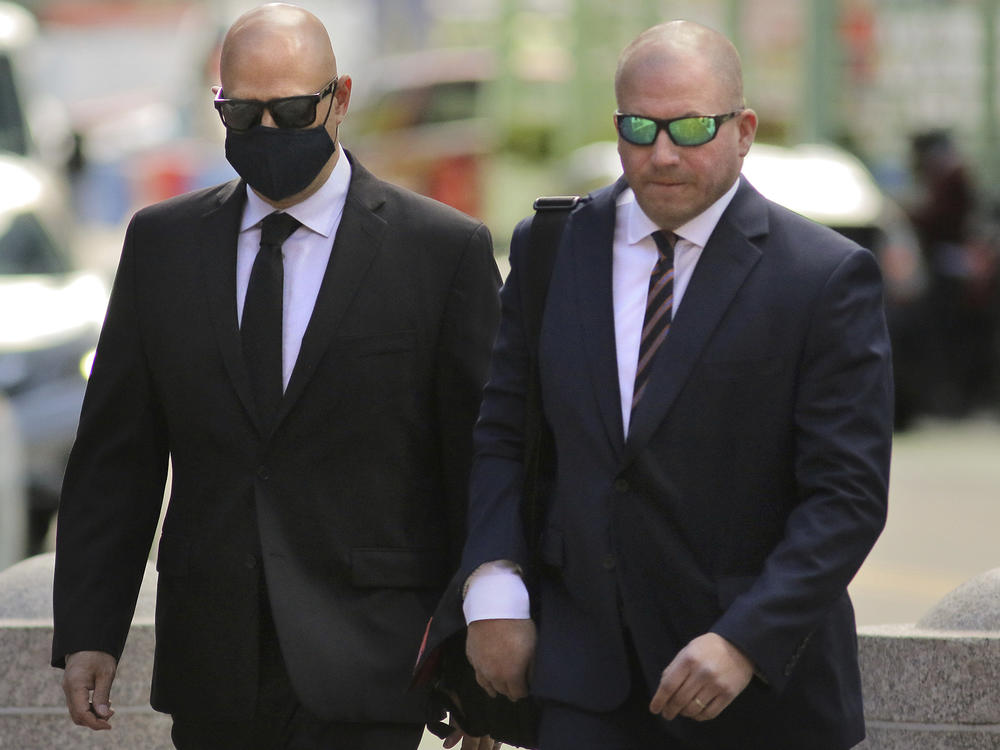 David Harville, left, arrives for sentencing in a cyberstalking case at Moakley Federal Court on Thursday, Sept. 29, 2022, in Boston.
