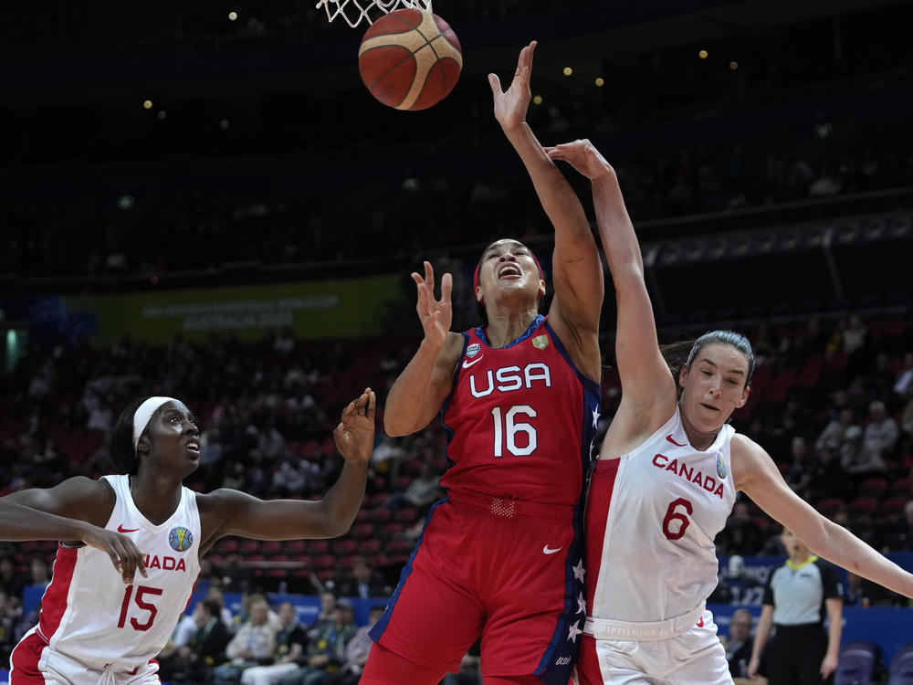 The United States' Brionna Jones (center) is fouled by Canada's Bridget Carleton, (right) during their semifinal game at the women's Basketball World Cup in Sydney on Friday.