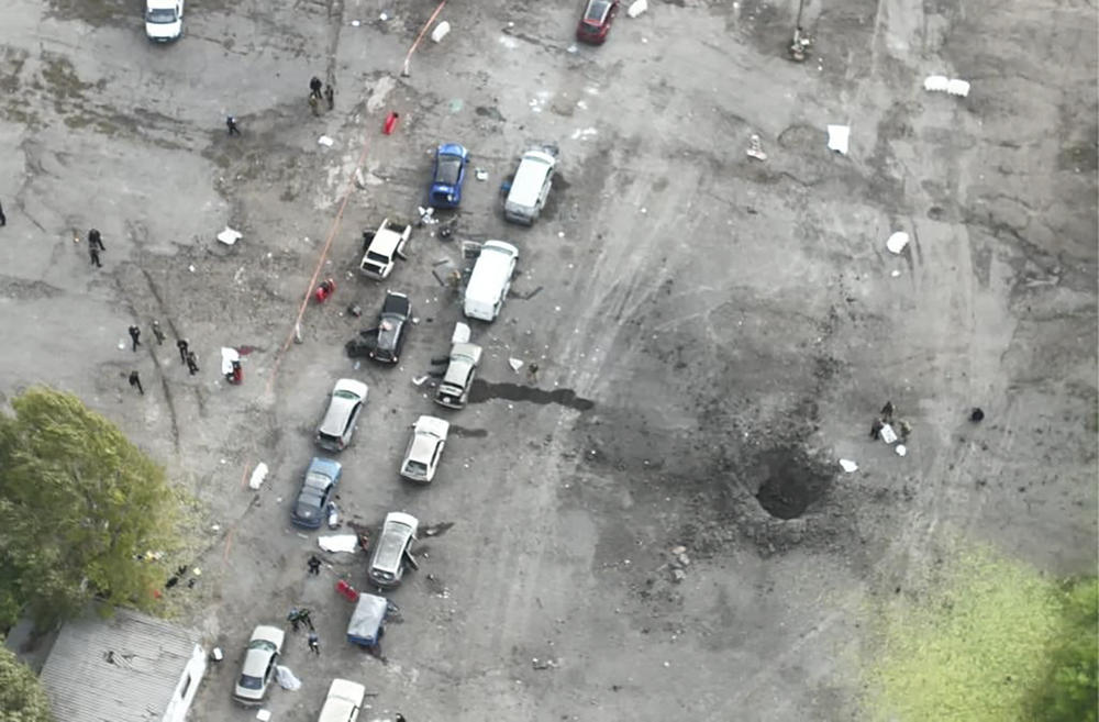 In this image released by the Ukrainian Police Press Service, the view from a drone shows the site of a Russian rocket attack in Zaporizhzhia on Friday. A Russian strike on the Ukrainian city killed at least 23 people and wounded dozens, an official said Friday, just hours before Moscow planned to annex more of Ukraine in an escalation of the seven-month war.