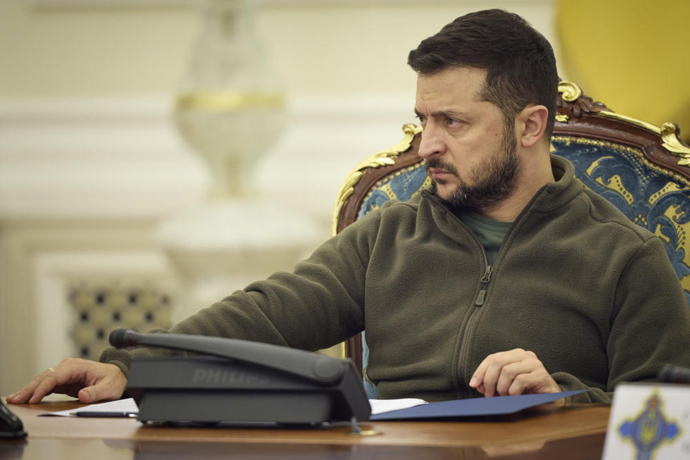 In this photo released by the Ukrainian Presidential Press Office, Ukrainian President Volodymyr Zelenskyy leads a meeting National Security and Defense Council meeting in Kyiv. He announced that his country is submitting an 