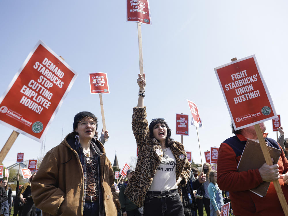 Marchers raise picket signs during a 