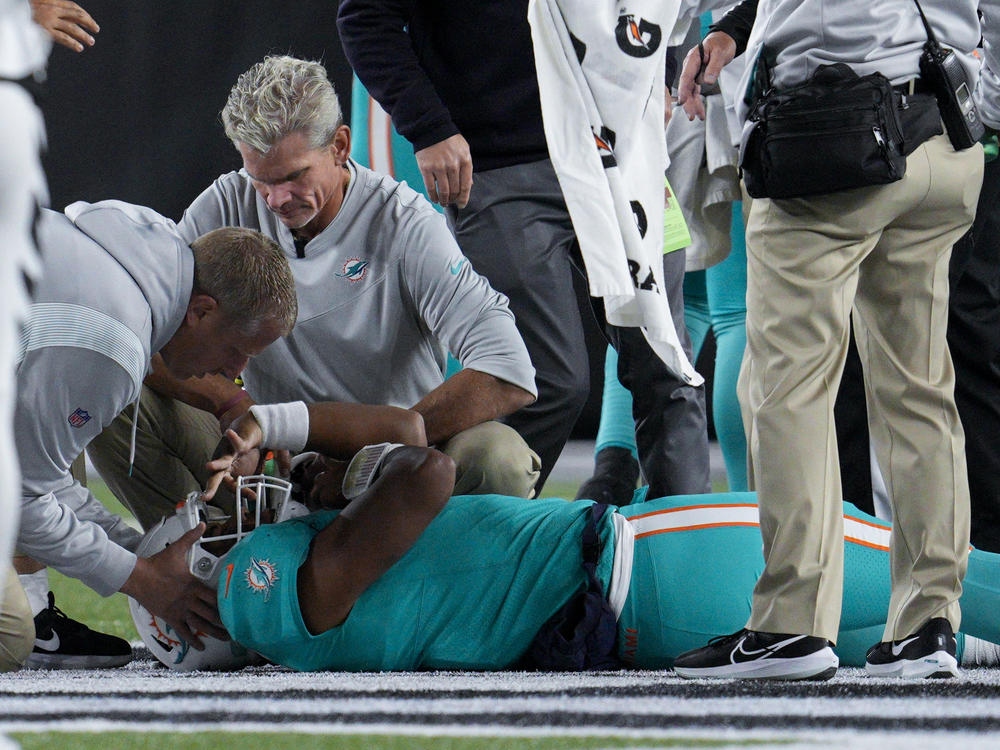 Medical staff attend to Miami Dolphins quarterback Tua Tagovailoa after he was sacked by Cincinnati Bengals defensive tackle Josh Tupou during an NFL game on Thursday.