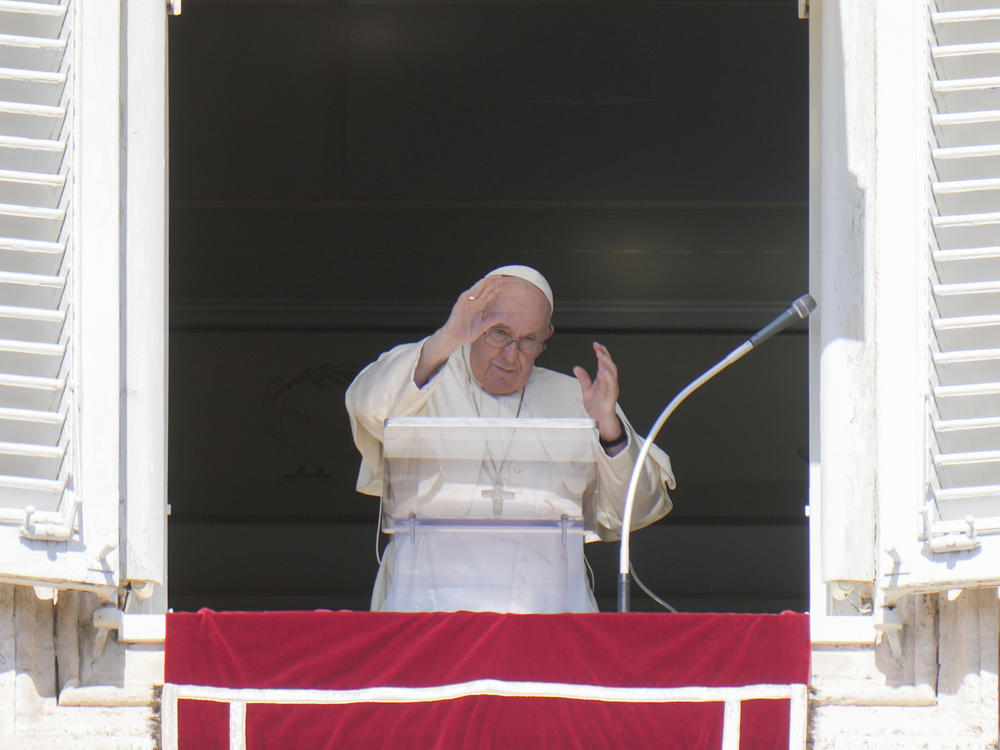 Pope Francis waves during the Angelus noon prayer from the window of his studio overlooking St. Peter's Square, at the Vatican on Sunday. He has appealed to Russian President Vladimir Putin, imploring him to 