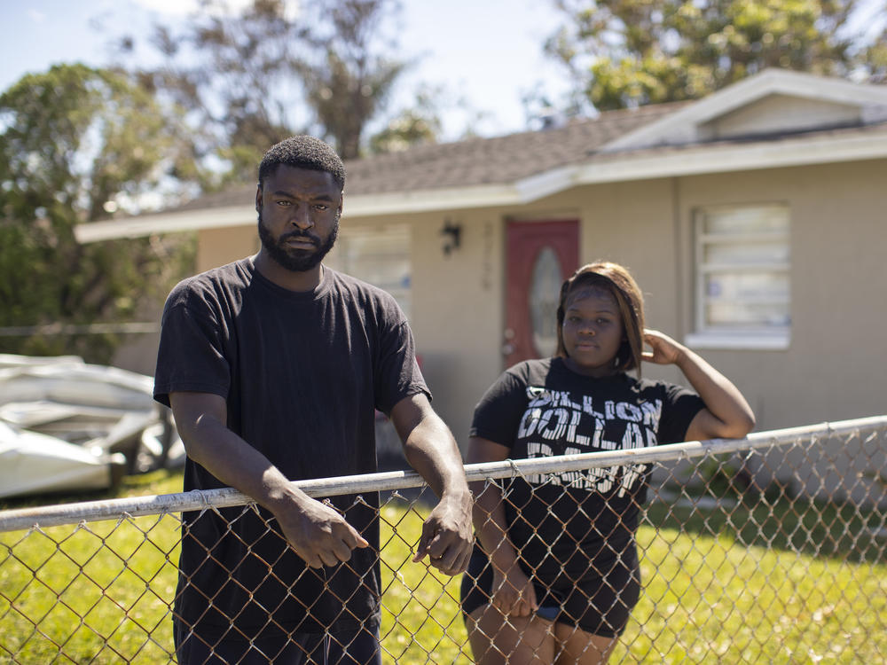 Ta'Wan Grant and Lexxus Cherry in the front yard of their home in the Dunbar neighborhood of Fort Myers, Fla., on Sunday.
