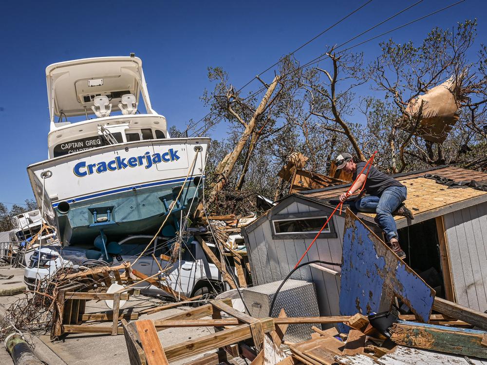 People clear debris in the aftermath of Hurricane Ian in Fort Myers Beach, Florida, on Friday.