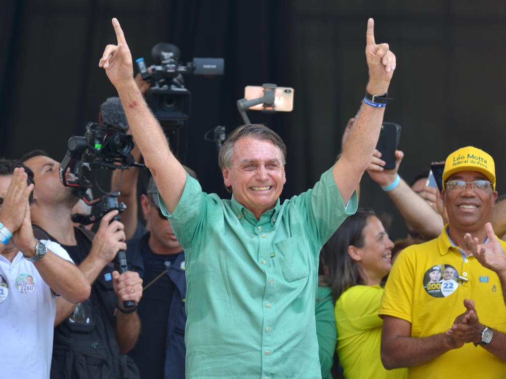 President of Brazil and presidential candidate Jair Bolsonaro greets supporters during a rally at Praca do Santuario on Sept. 23 in Divinopolis, Brazil.