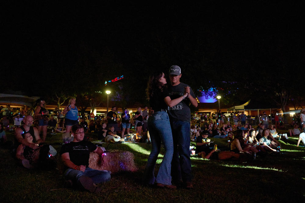Ashley Auakian and Hunter Curland dance during Remember Music Festival at Clark County Government Center Amphitheater in Las Vegas, Nevada on Oct. 1, 2022.