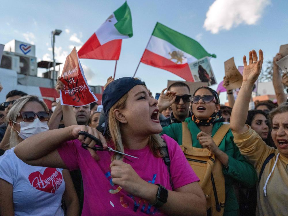 A protestor cuts her hair during a demonstration against the Iranian government and in support of Iranian women in Istanbul on Sunday.