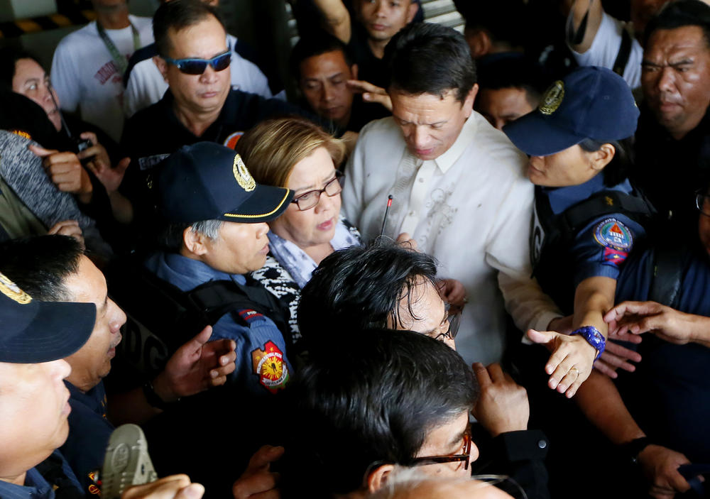 Leila de Lima (center), then an opposition senator, is escorted to her detention a day after a warrant for her arrest was issued by a regional trial court in Pasay, Philippines on Feb. 24, 2017. De Lima was arrested on drug charges but professed her innocence and vowed she would not be intimidated by a leader she called a 